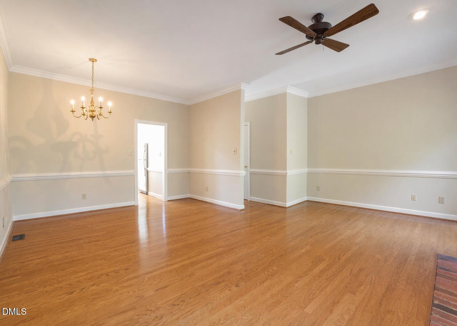 5018 Dunwoody Trail Raleigh, NC 27606 - Photo 9 of 24 a view of an empty room with wooden floor and a window