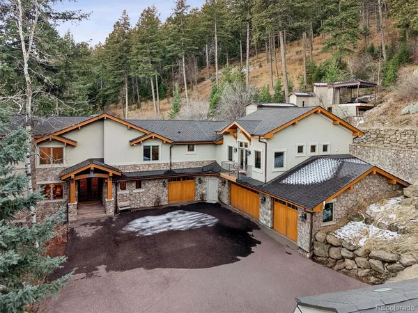 an aerial view of a house with swimming pool and furniture