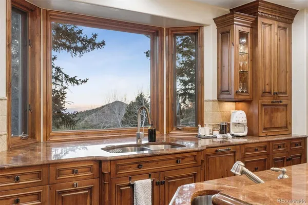 a view of a kitchen with a sink and cabinets