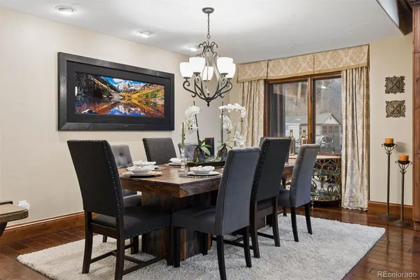 a dining room with furniture a rug and wooden floor