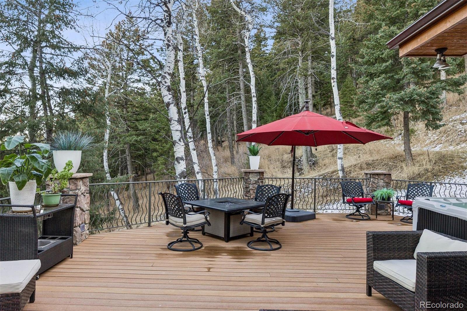 45 West Ranch Trail Morrison, CO 80465 - Photo 20 of 50 a view of a rooftop deck with chairs and wooden floor