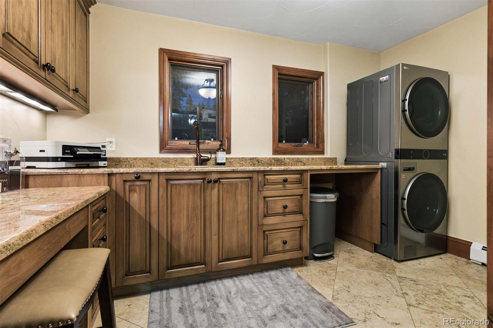 45 West Ranch Trail Morrison, CO 80465 - Photo 27 of 50 a kitchen with stainless steel appliances granite countertop a stove a sink and a cabinets