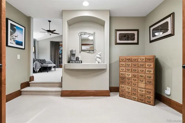 a spacious bedroom with a bed and a chandelier