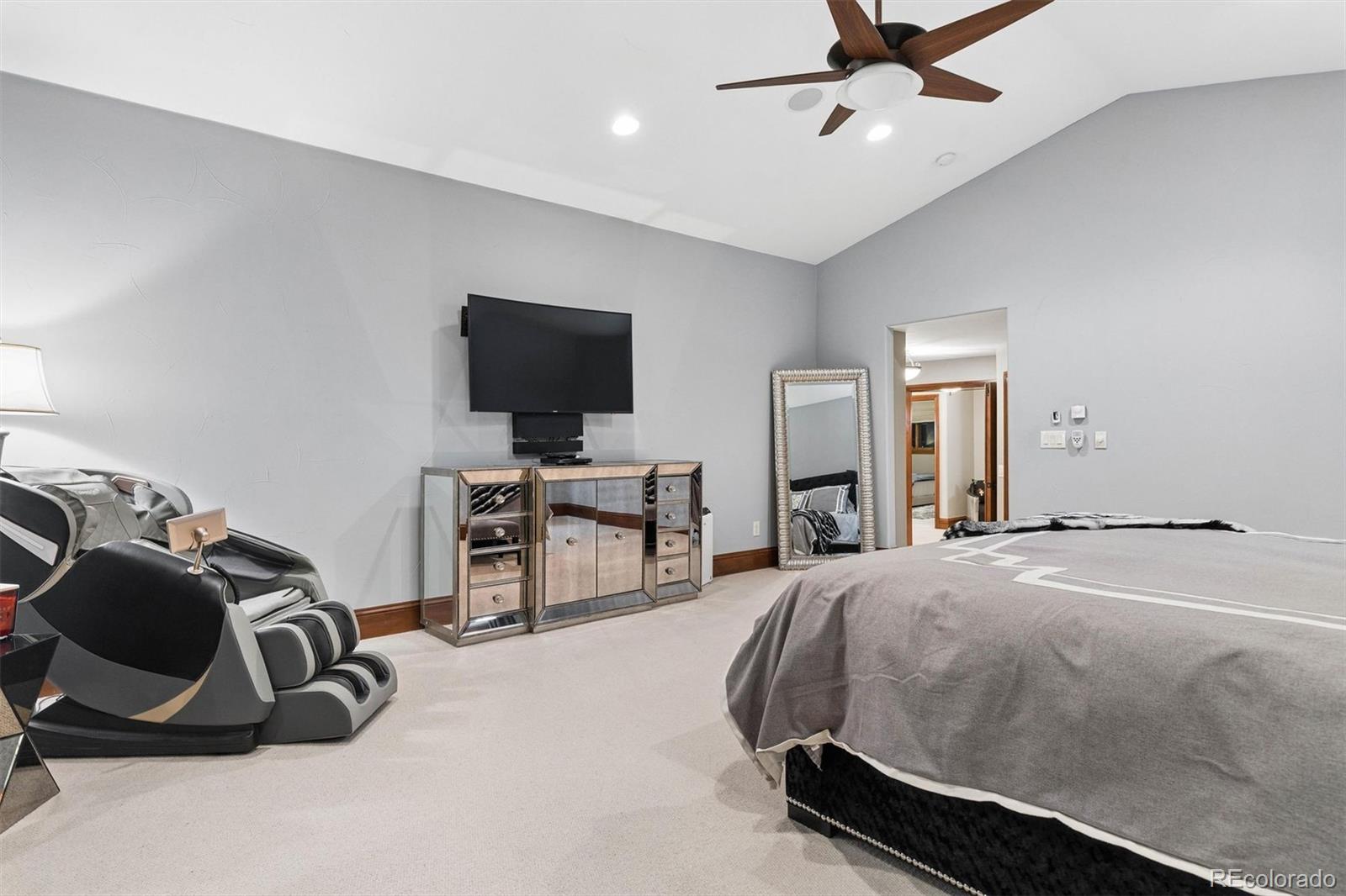 45 West Ranch Trail Morrison, CO 80465 - Photo 33 of 50 a bedroom with a bed and a flat screen tv