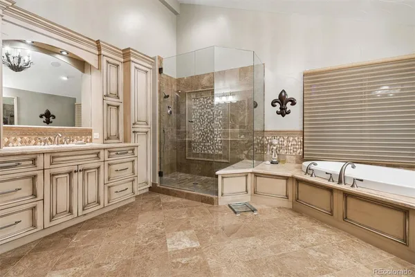 a spacious bathroom with a shower a sink and mirror