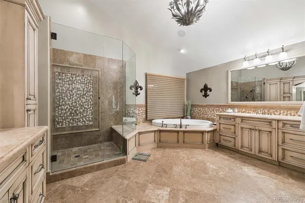 a bathroom with a tub sink and mirror