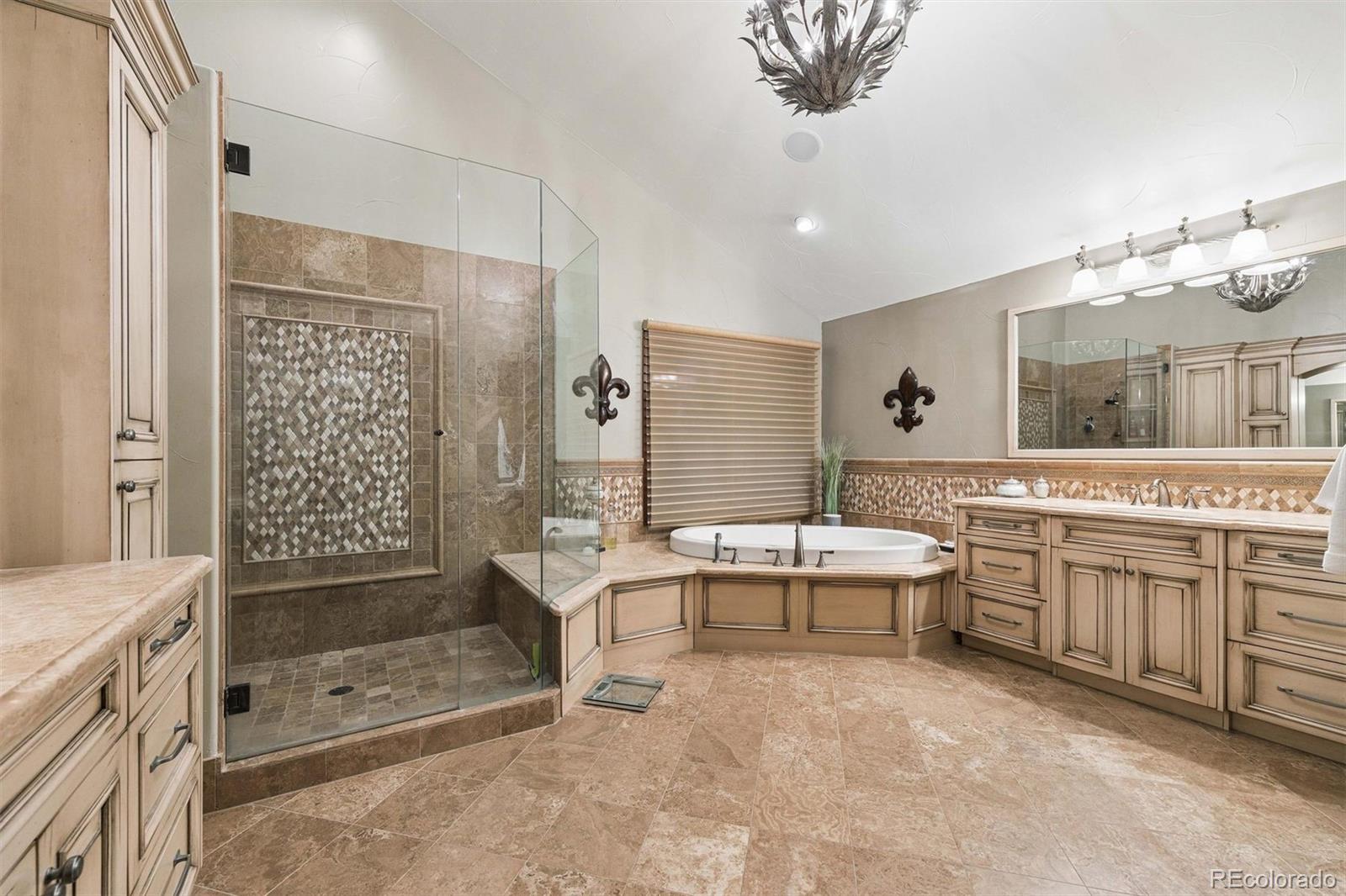 45 West Ranch Trail Morrison, CO 80465 - Photo 36 of 50 a spacious bathroom with a shower a sink and mirror