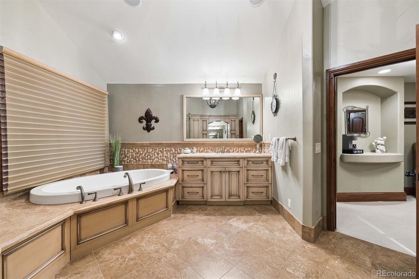 45 West Ranch Trail Morrison, CO 80465 - Photo 37 of 50 a bathroom with a tub sink and mirror
