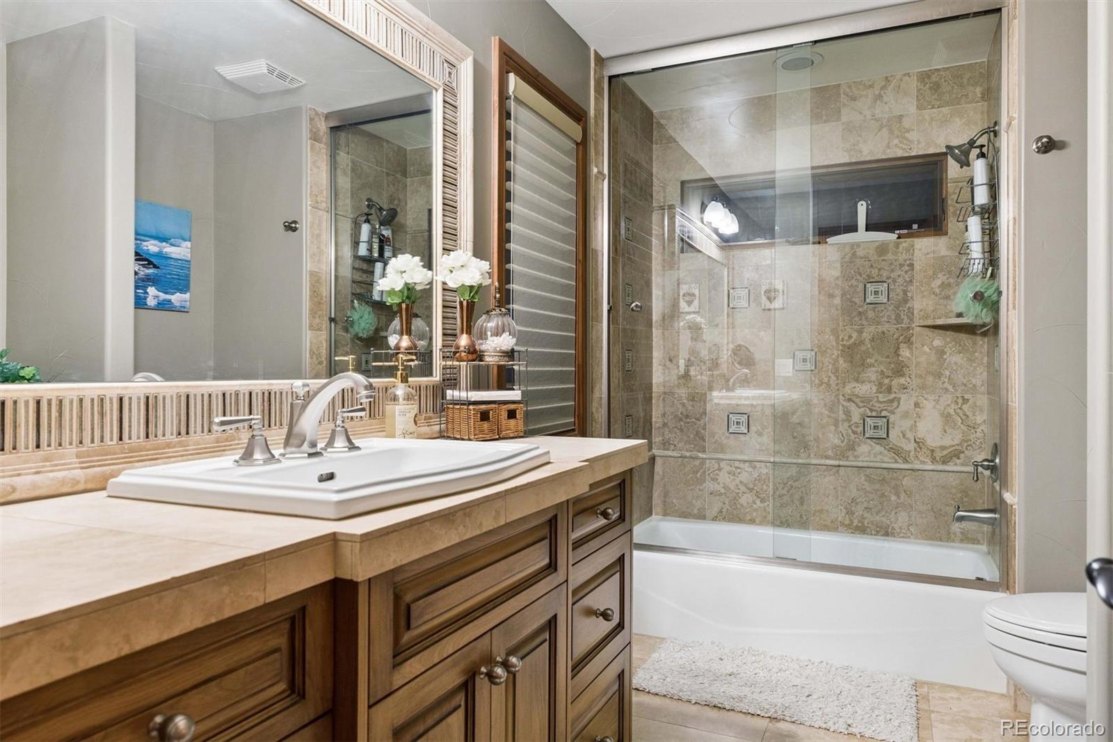 45 West Ranch Trail Morrison, CO 80465 - Photo 39 of 50 a bathroom with a bathtub and a sink