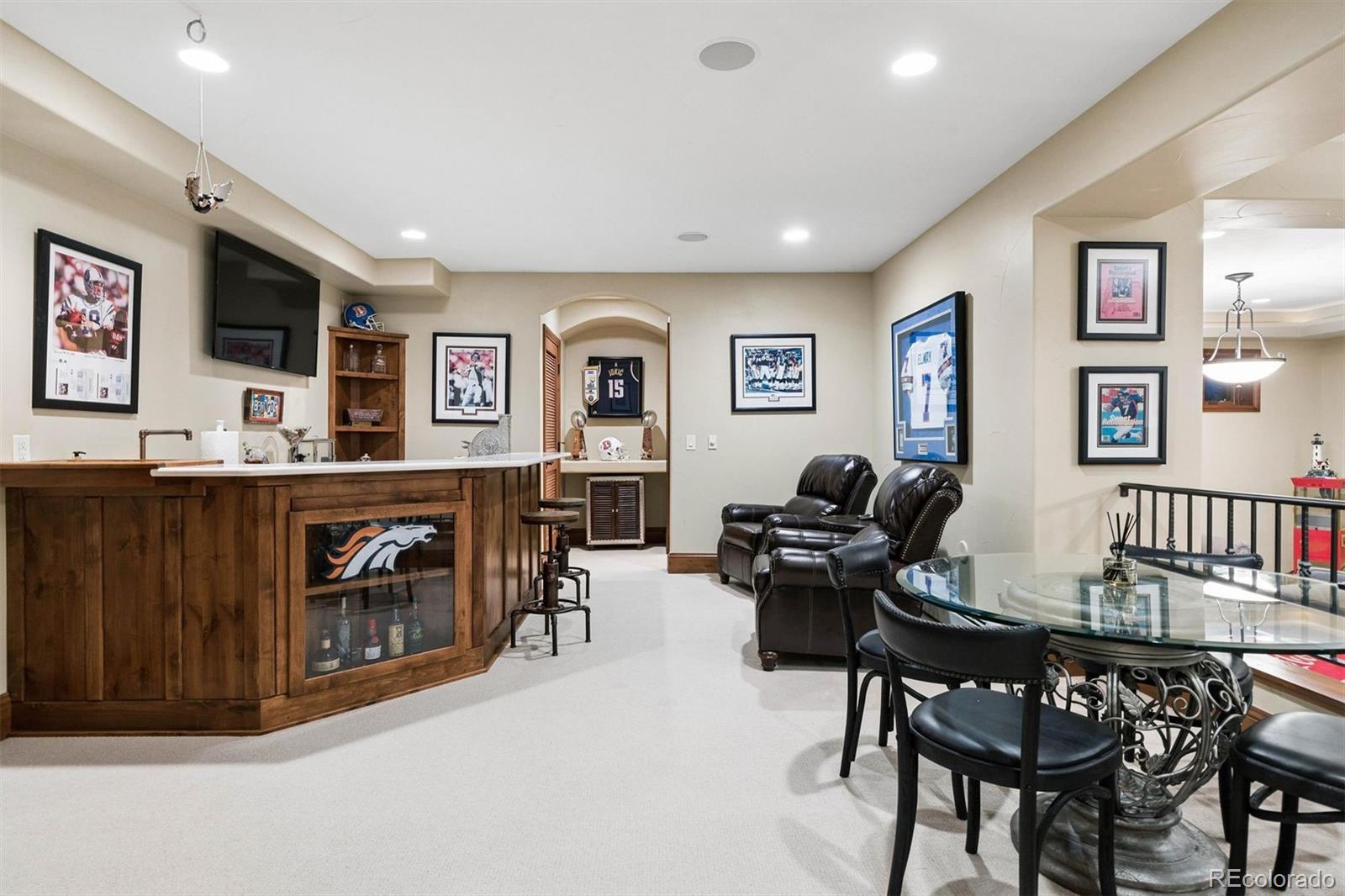 45 West Ranch Trail Morrison, CO 80465 - Photo 45 of 50 a living room with furniture a piano and a flat screen tv