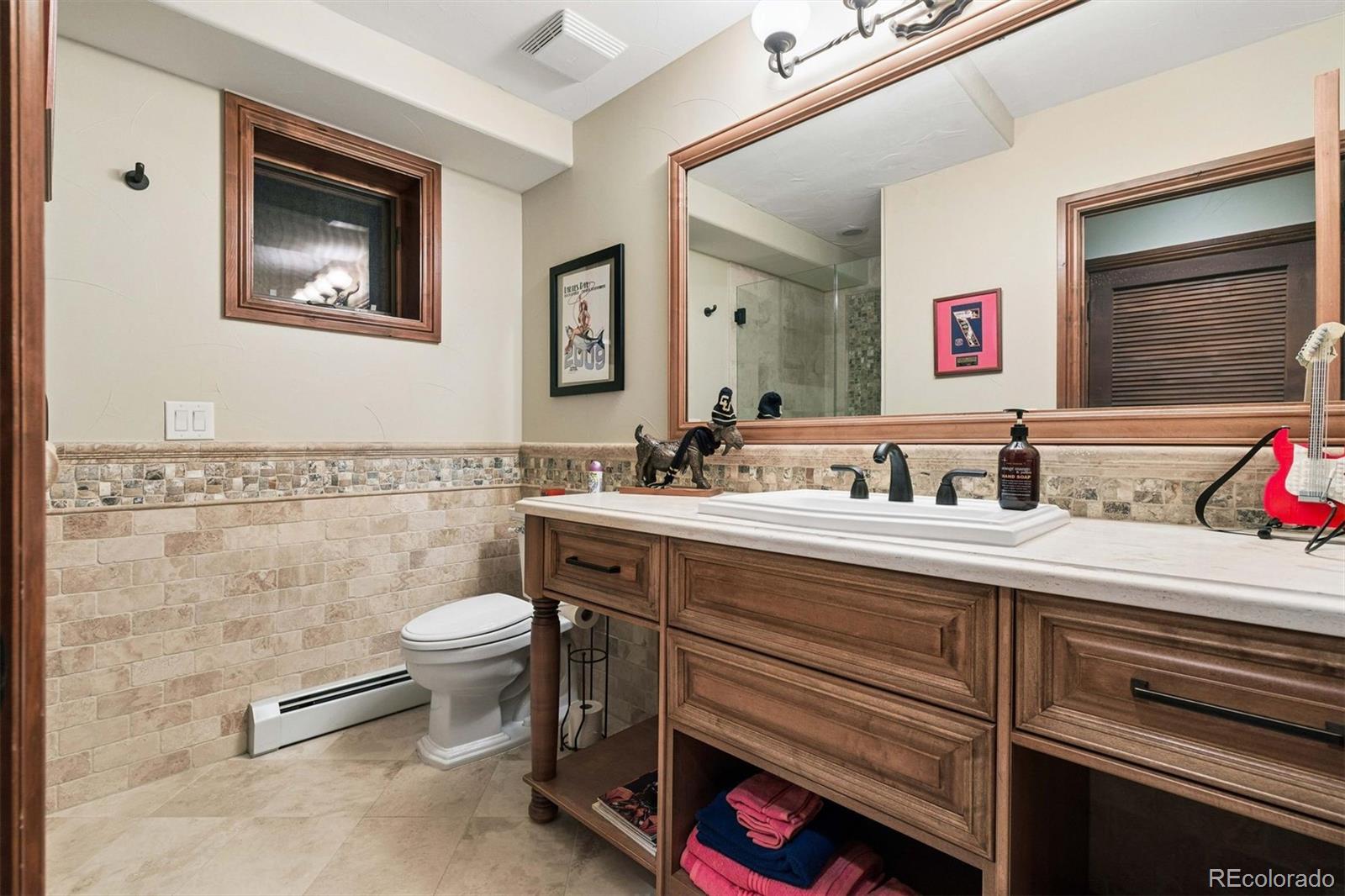 45 West Ranch Trail Morrison, CO 80465 - Photo 46 of 50 a bathroom with a toilet sink and mirror