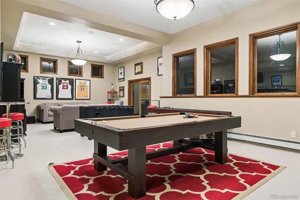 a living room with furniture and rug table