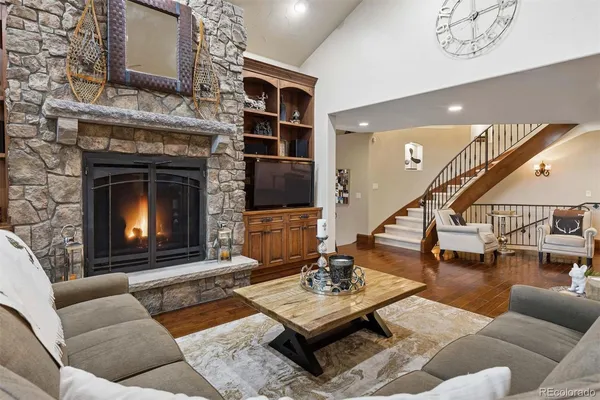 a living room with furniture a table and a fireplace