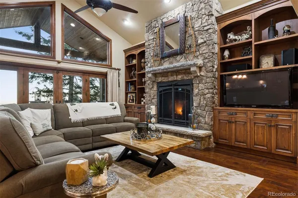 a living room with furniture a flat screen tv and a fireplace