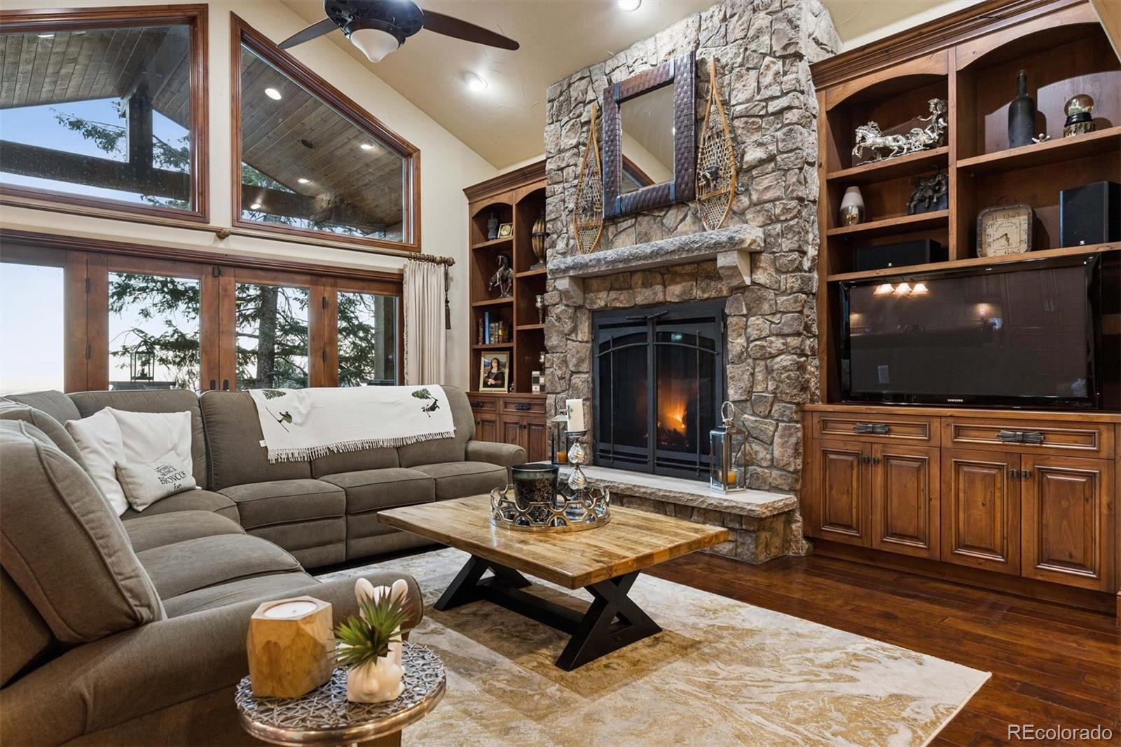 45 West Ranch Trail Morrison, CO 80465 - Photo 6 of 50 a living room with furniture a flat screen tv and a fireplace