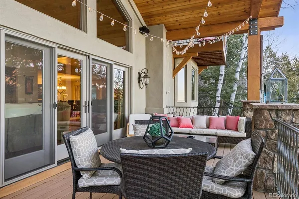 a outdoor space with patio the couches and a dining table with the view of the balcony