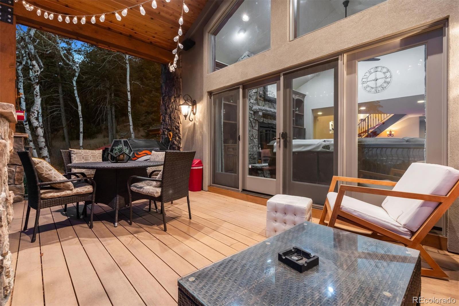 45 West Ranch Trail Morrison, CO 80465 - Photo 9 of 50 a outdoor space with patio furniture and wooden floor