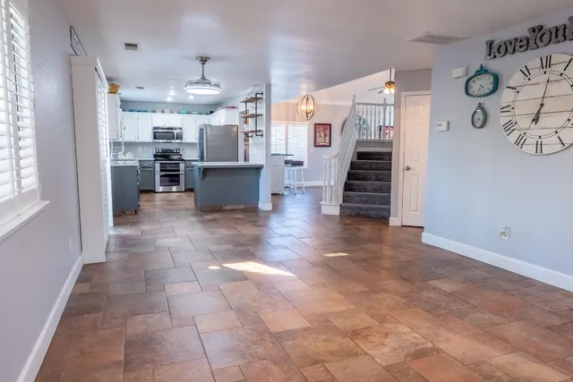a view of a kitchen with furniture and wooden floor