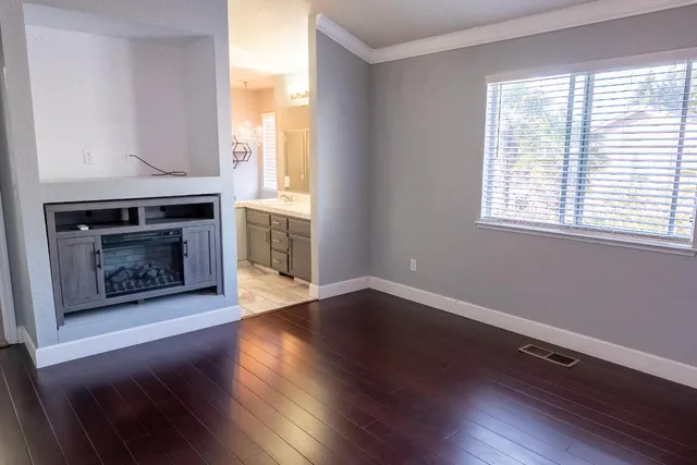 a view of a room with wooden floors and fireplace