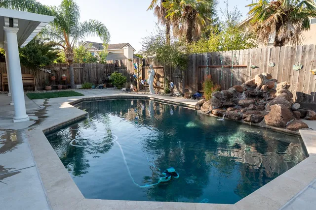a view of a swimming pool with a patio