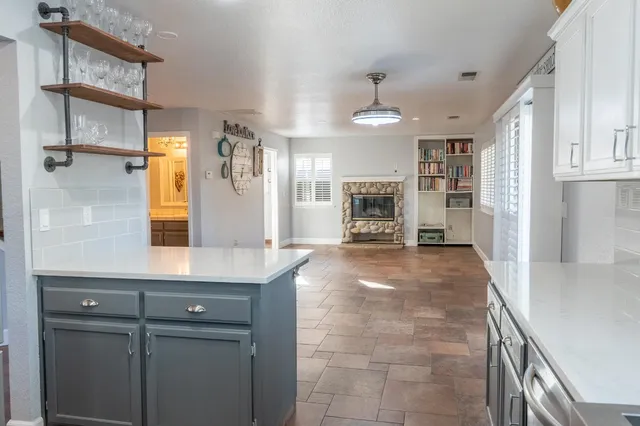 a view of a kitchen with a sink and a refrigerator