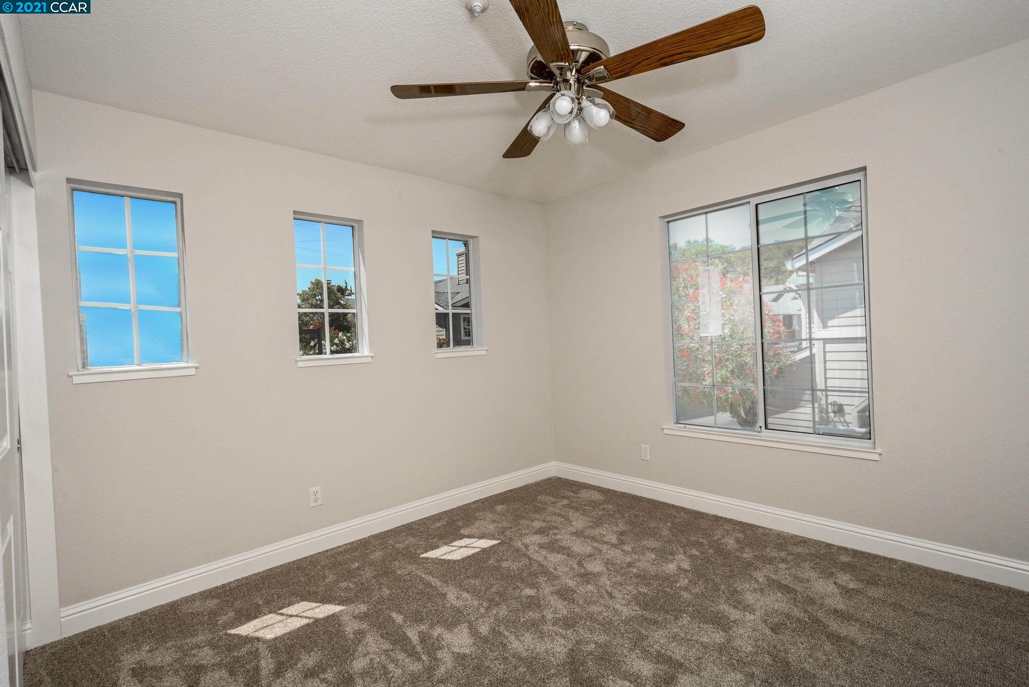 703 Destiny Lane San Ramon, CA 94583 - Photo 12 of 22 an empty room with windows and fan