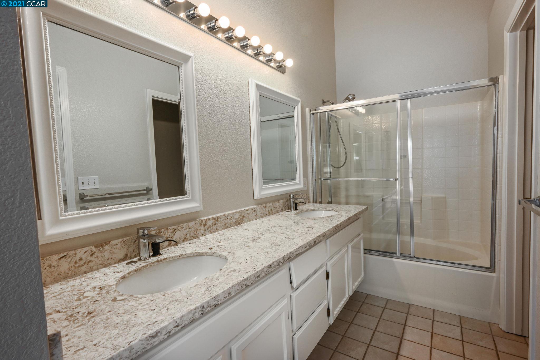 703 Destiny Lane San Ramon, CA 94583 - Photo 17 of 22 a bathroom with a granite countertop sink and a mirror