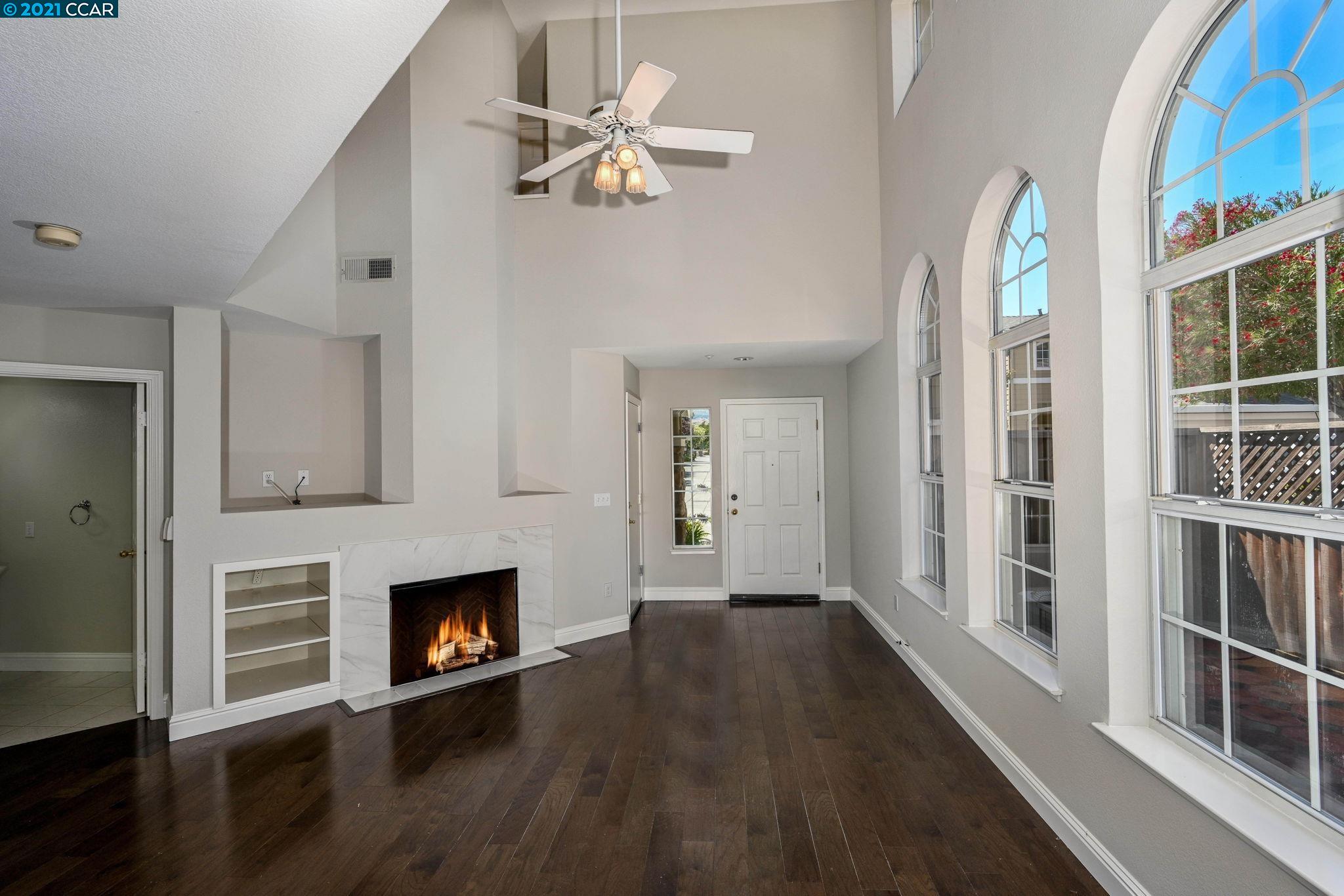 703 Destiny Lane San Ramon, CA 94583 - Photo 4 of 22 a view of a livingroom with wooden floor and a fireplace