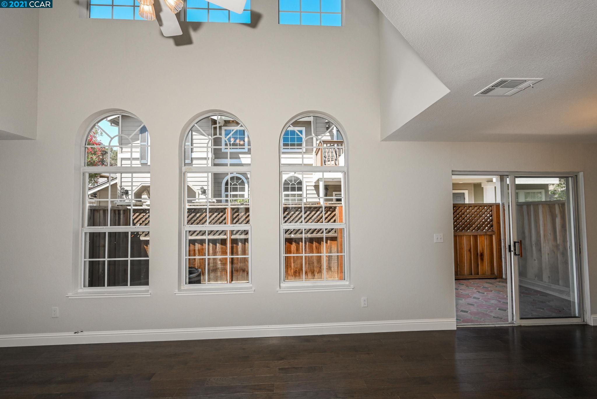 703 Destiny Lane San Ramon, CA 94583 - Photo 5 of 22 an empty room with wooden floor and windows