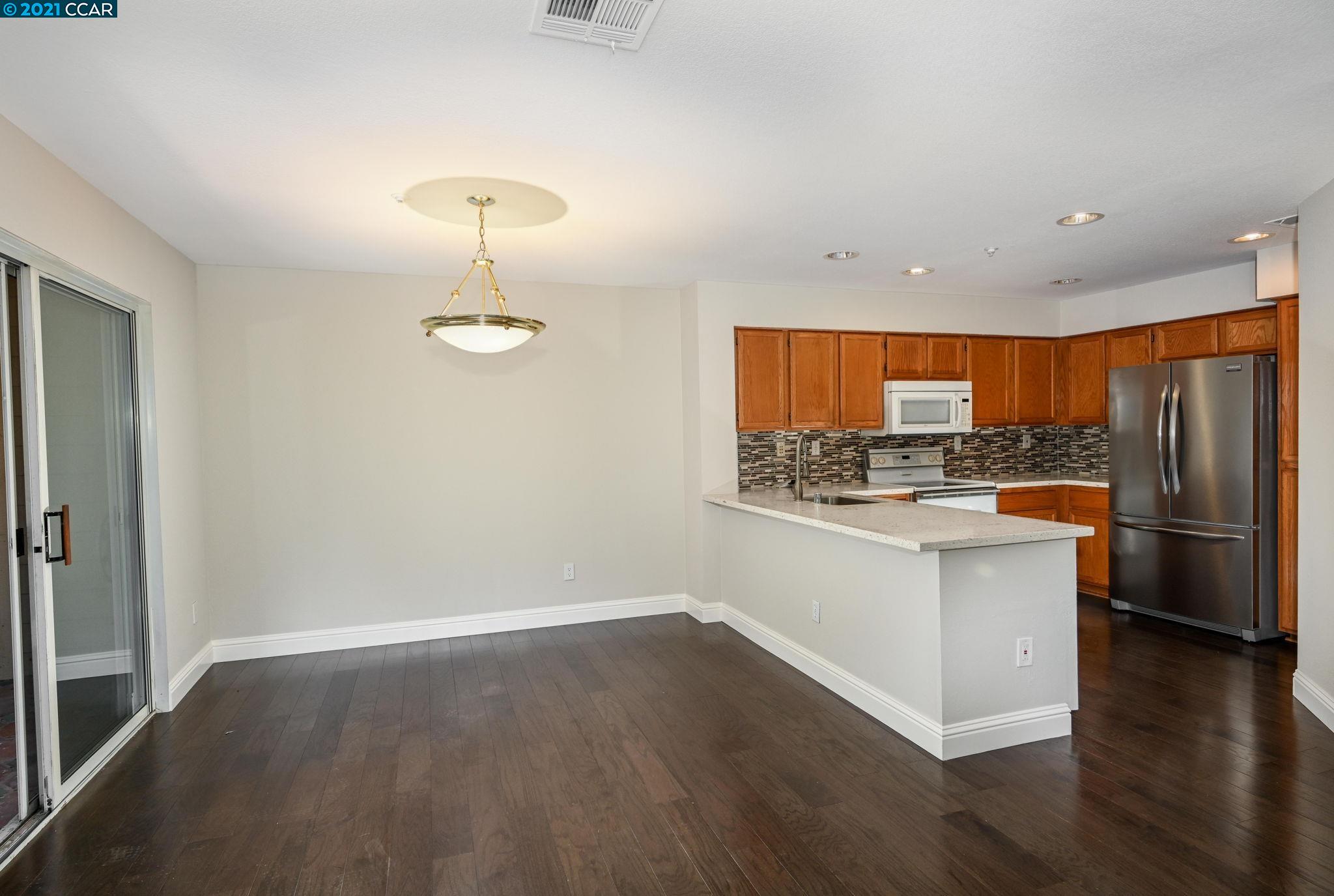 703 Destiny Lane San Ramon, CA 94583 - Photo 7 of 22 a kitchen with stainless steel appliances granite countertop a refrigerator a stove and a wooden floors