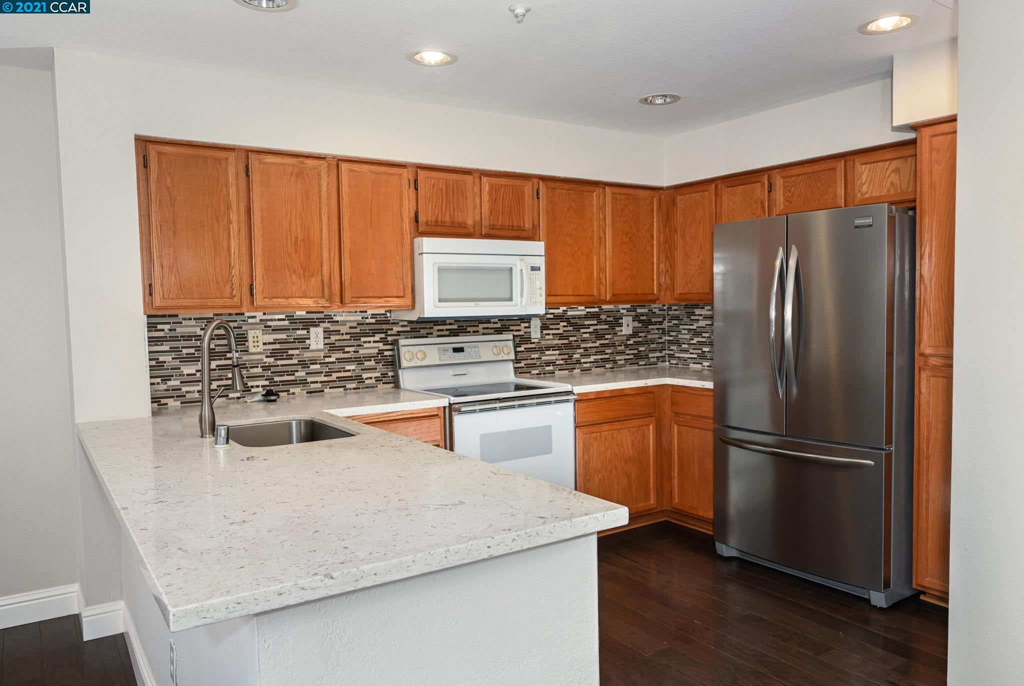 703 Destiny Lane San Ramon, CA 94583 - Photo 8 of 22 a kitchen with a refrigerator sink and stove