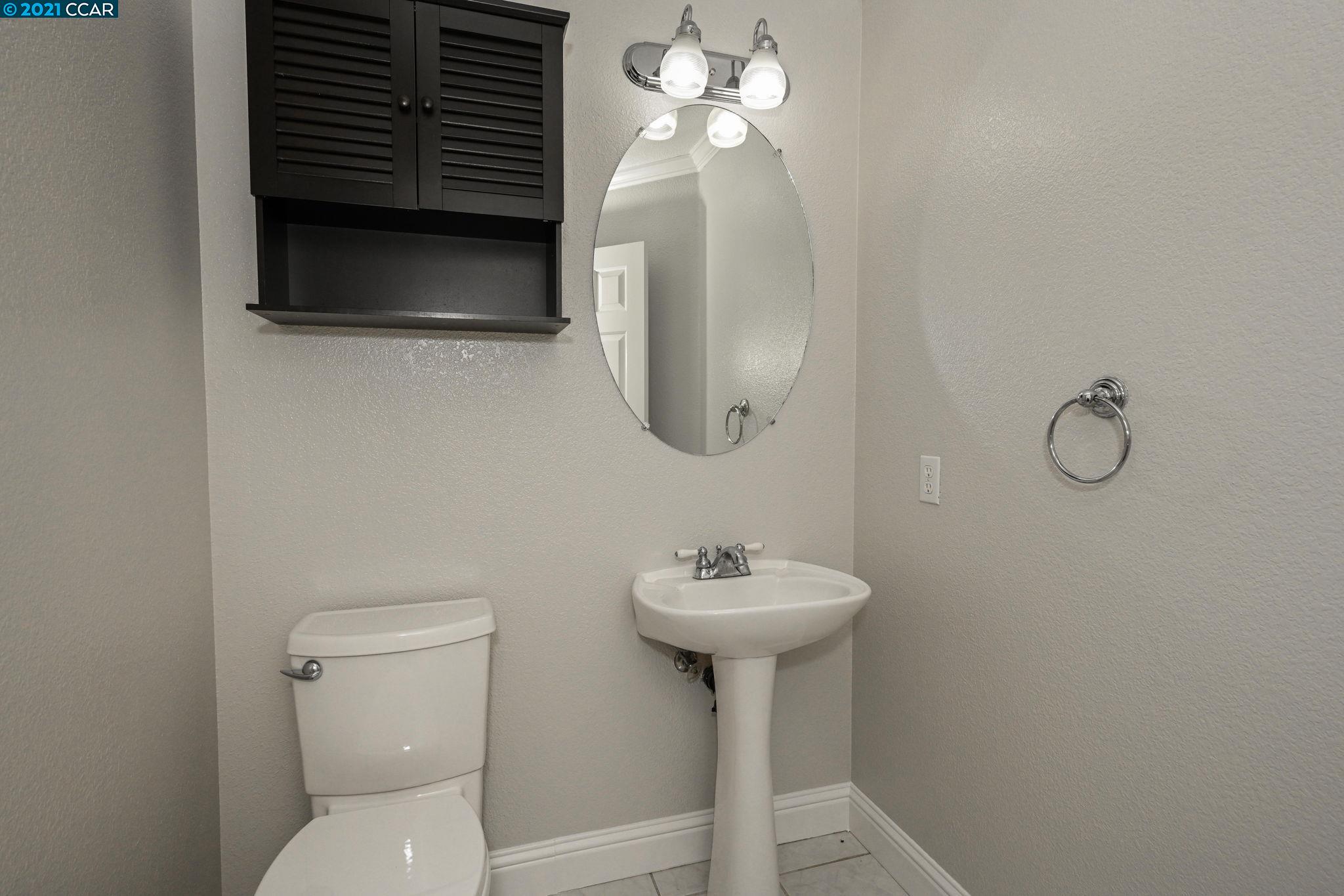 703 Destiny Lane San Ramon, CA 94583 - Photo 9 of 22 a bathroom with a toilet sink and mirror