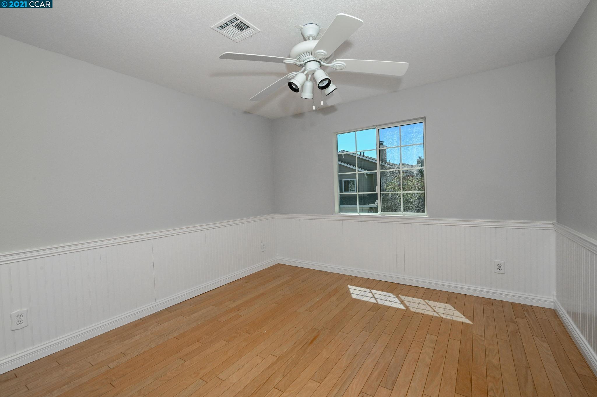 703 Destiny Lane San Ramon, CA 94583 - Photo 10 of 22 wooden floor in an empty room with a window