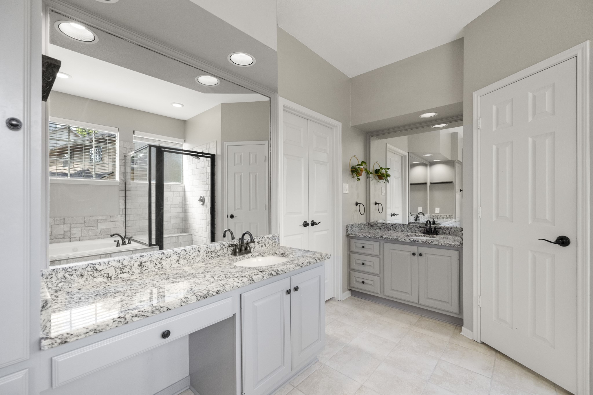102 Treescape Circle Spring, TX 77381 - Photo 14 of 40 A large mirror enhances the bright, airy feel, and a glass-enclosed shower adds a touch of luxury.