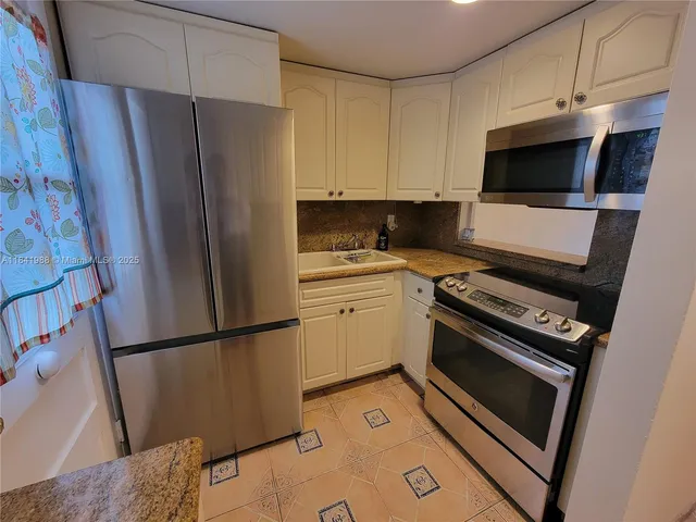 a kitchen with a refrigerator stove and microwave