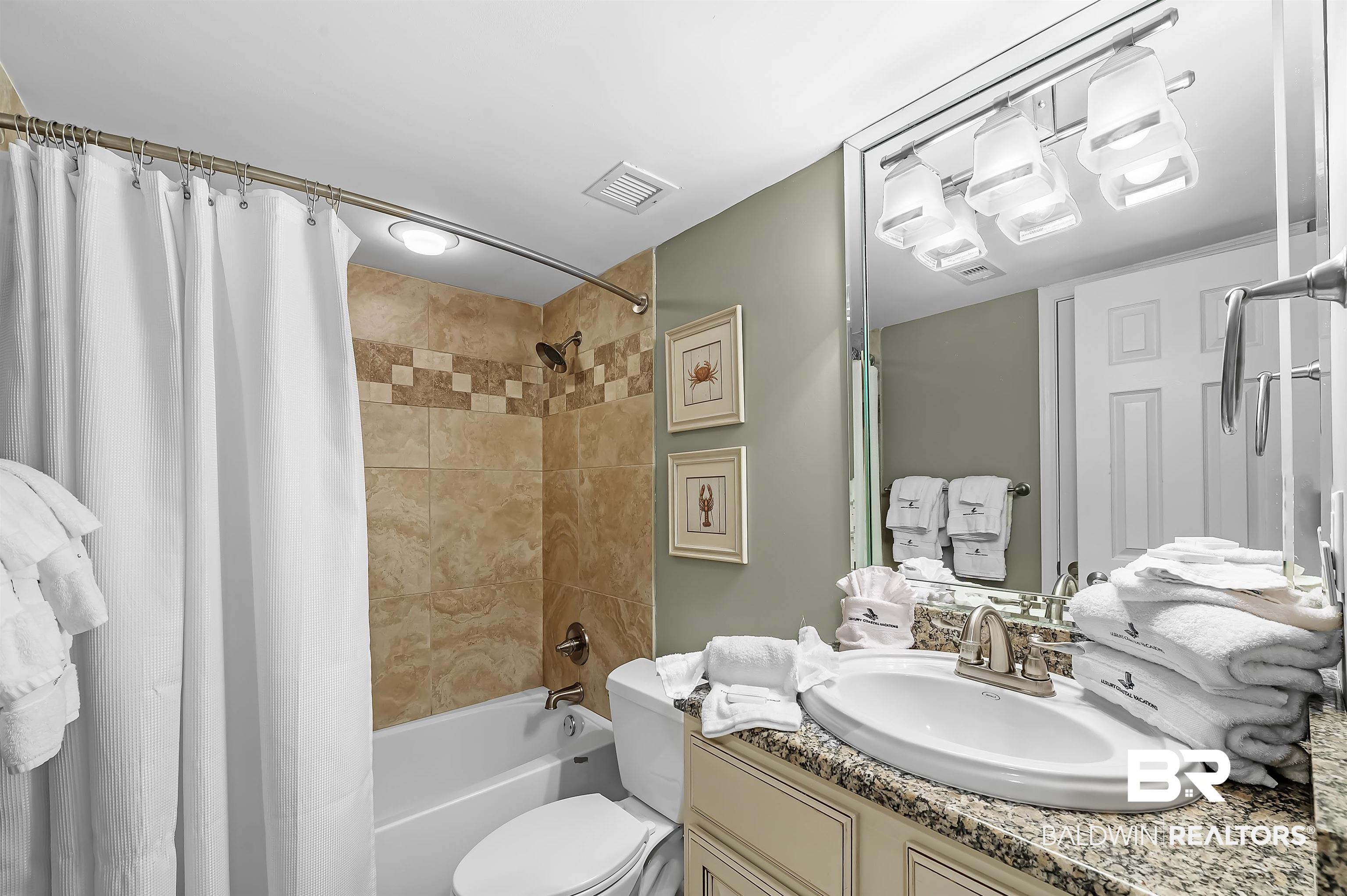 16287 Perdido Key Drive, Unit 105 Pensacola, FL 32507 - Photo 33 of 66 Bathroom featuring a built-in bathtub with shower, tiled surround, and curved shower rod