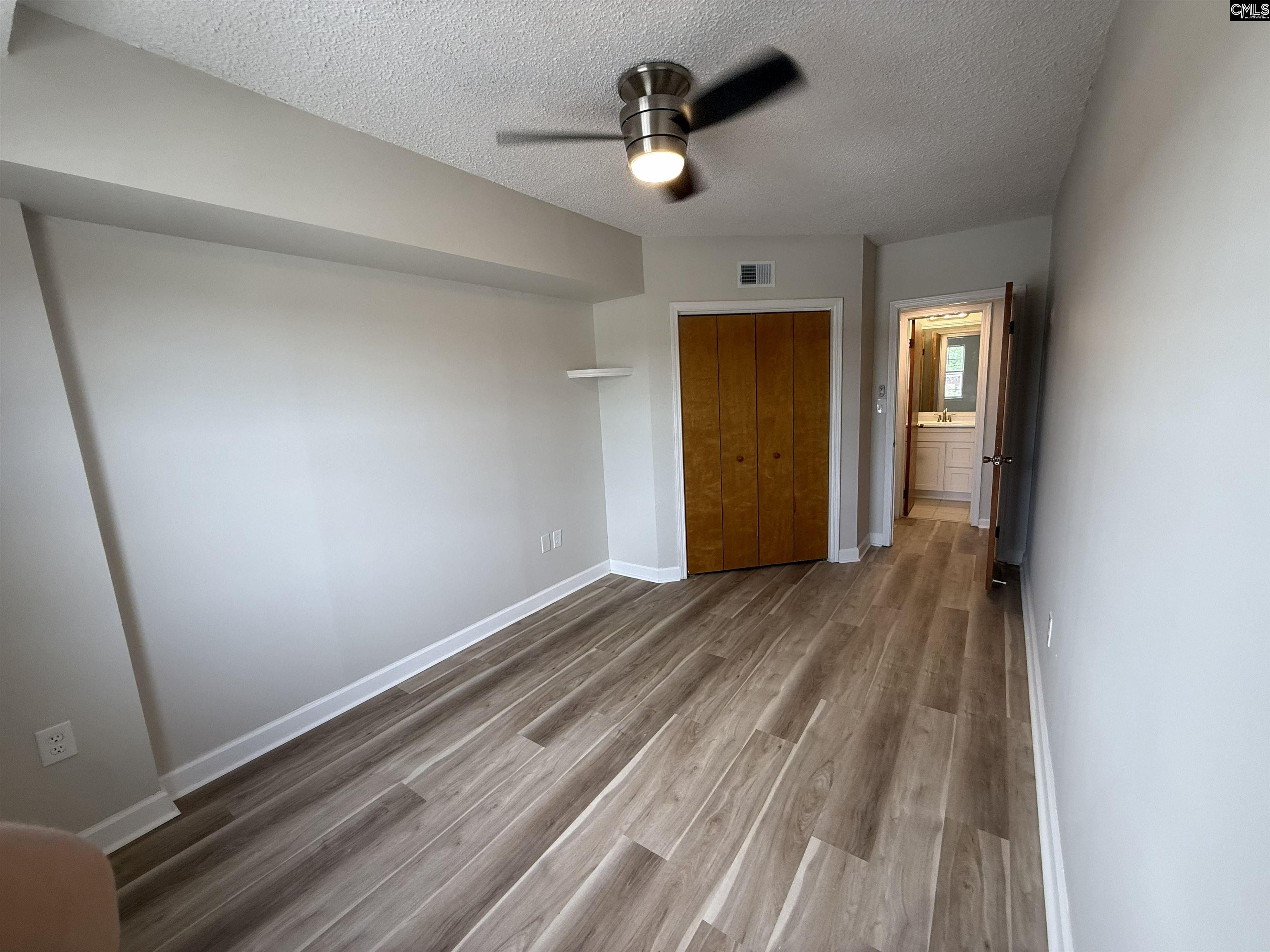 2002 Greene Street, Unit 209 Columbia, SC 29205 - Photo 10 of 22 wooden floor in an empty room with a window