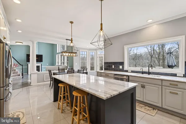 a kitchen with center island table and chairs