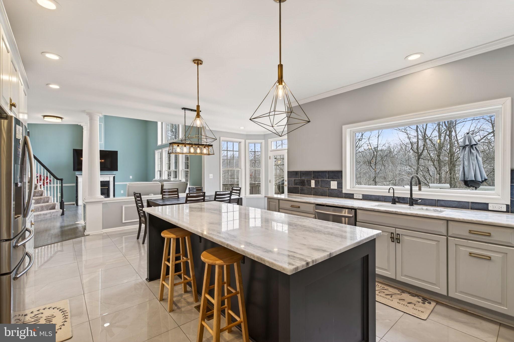 8020 Pohick Road Springfield, VA 22153 - Photo 13 of 57 a kitchen with center island table and chairs