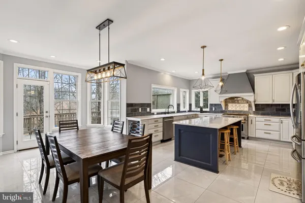 a kitchen with cabinets and wooden floor