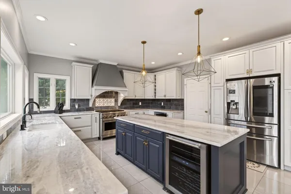 a kitchen with a stove a sink and a window