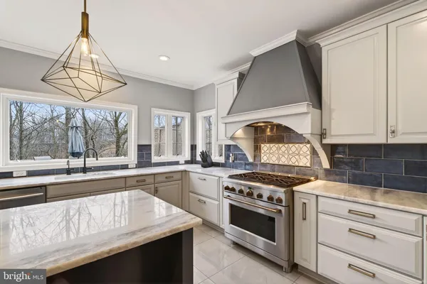 a kitchen with a sink a stove and cabinets