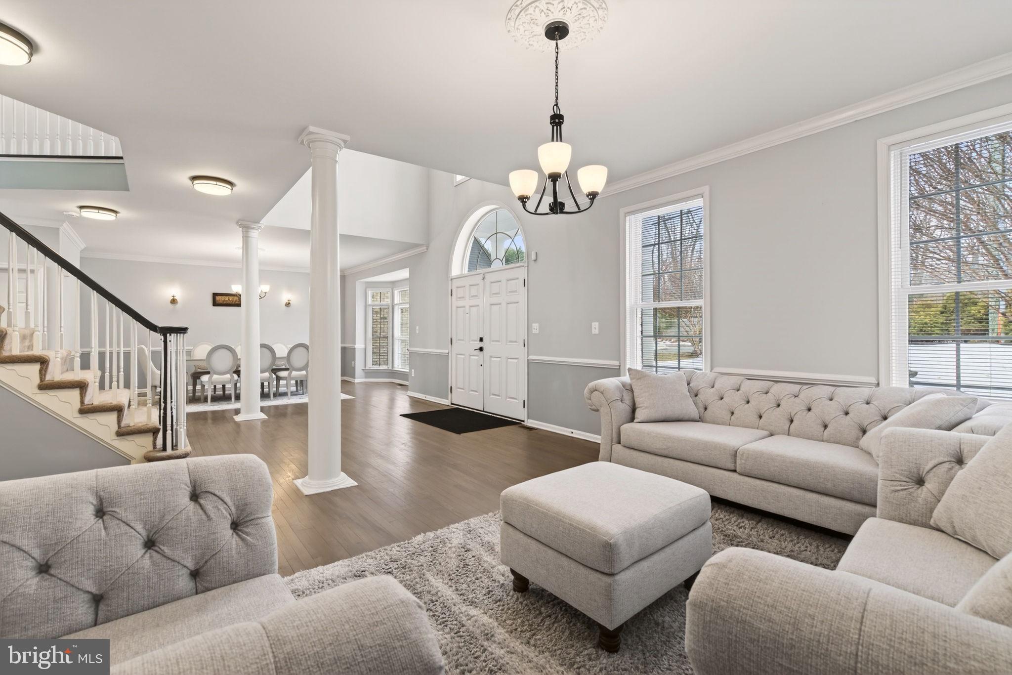 8020 Pohick Road Springfield, VA 22153 - Photo 2 of 57 a living room with furniture wooden floor and a chandelier