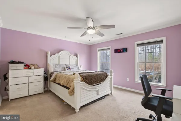 a spacious bedroom with a bed and a chair