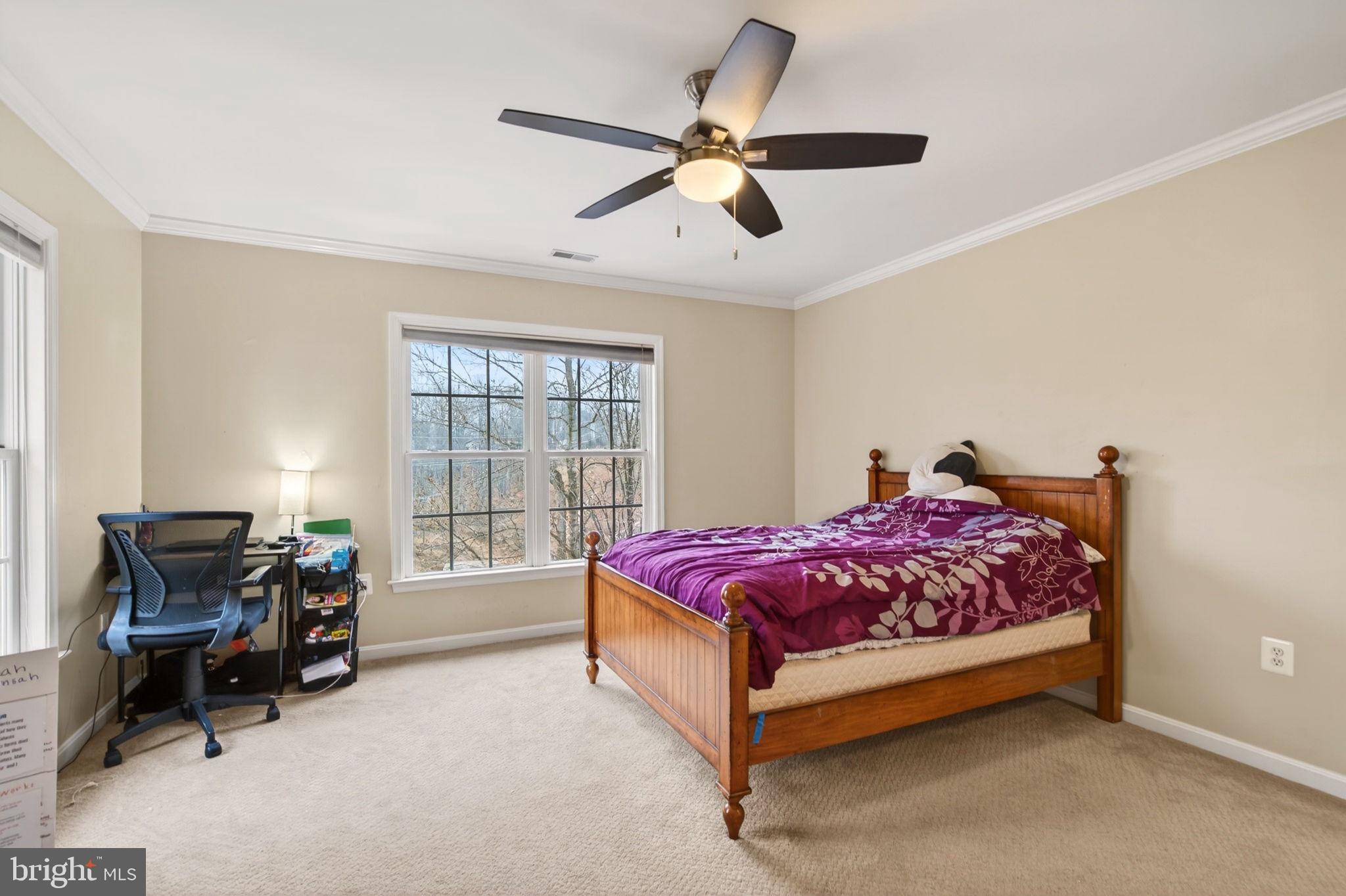 8020 Pohick Road Springfield, VA 22153 - Photo 24 of 57 a spacious bedroom with a bed and a chair