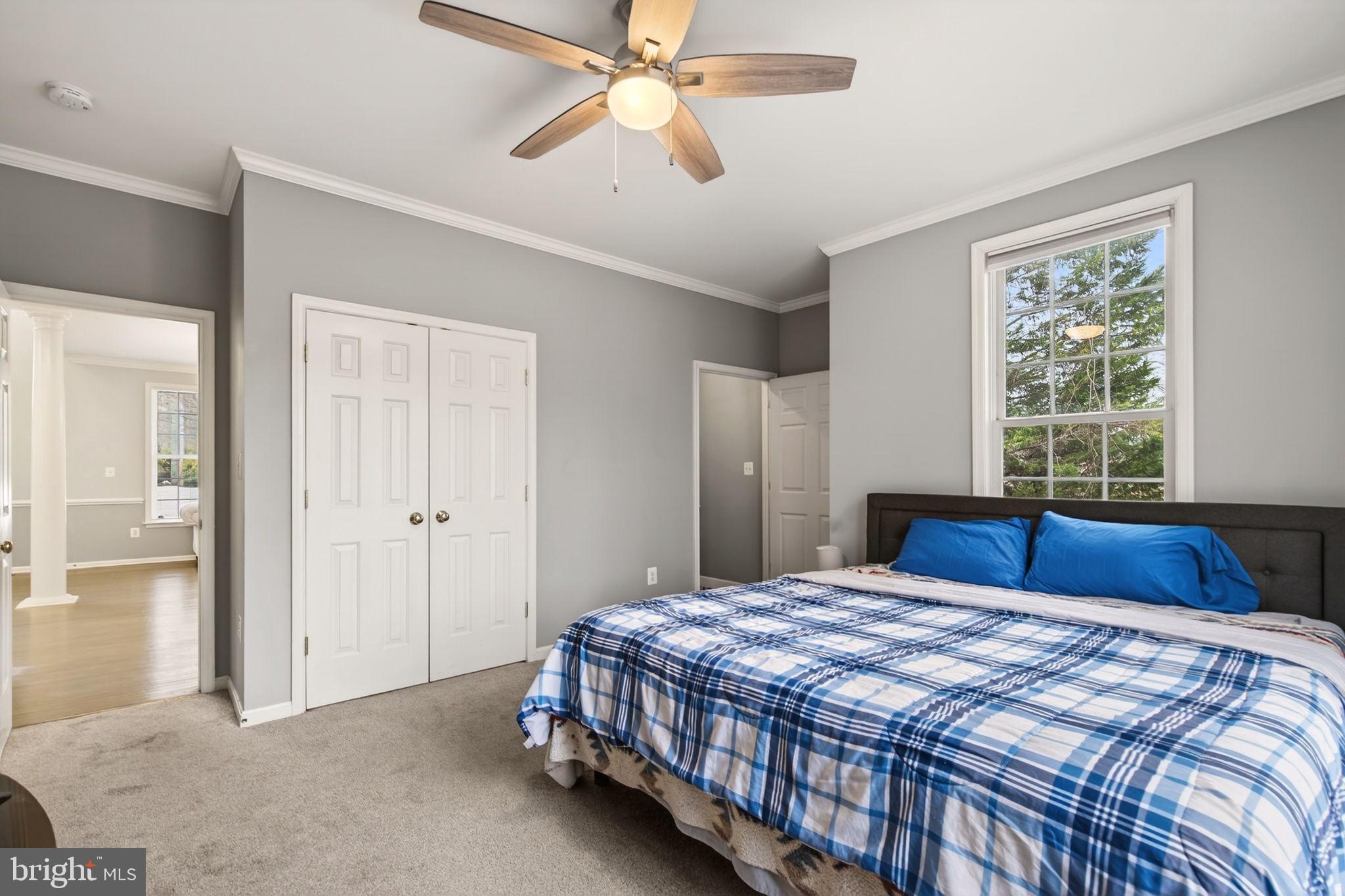 8020 Pohick Road Springfield, VA 22153 - Photo 25 of 57 a bedroom with a large bed and a chandelier fan