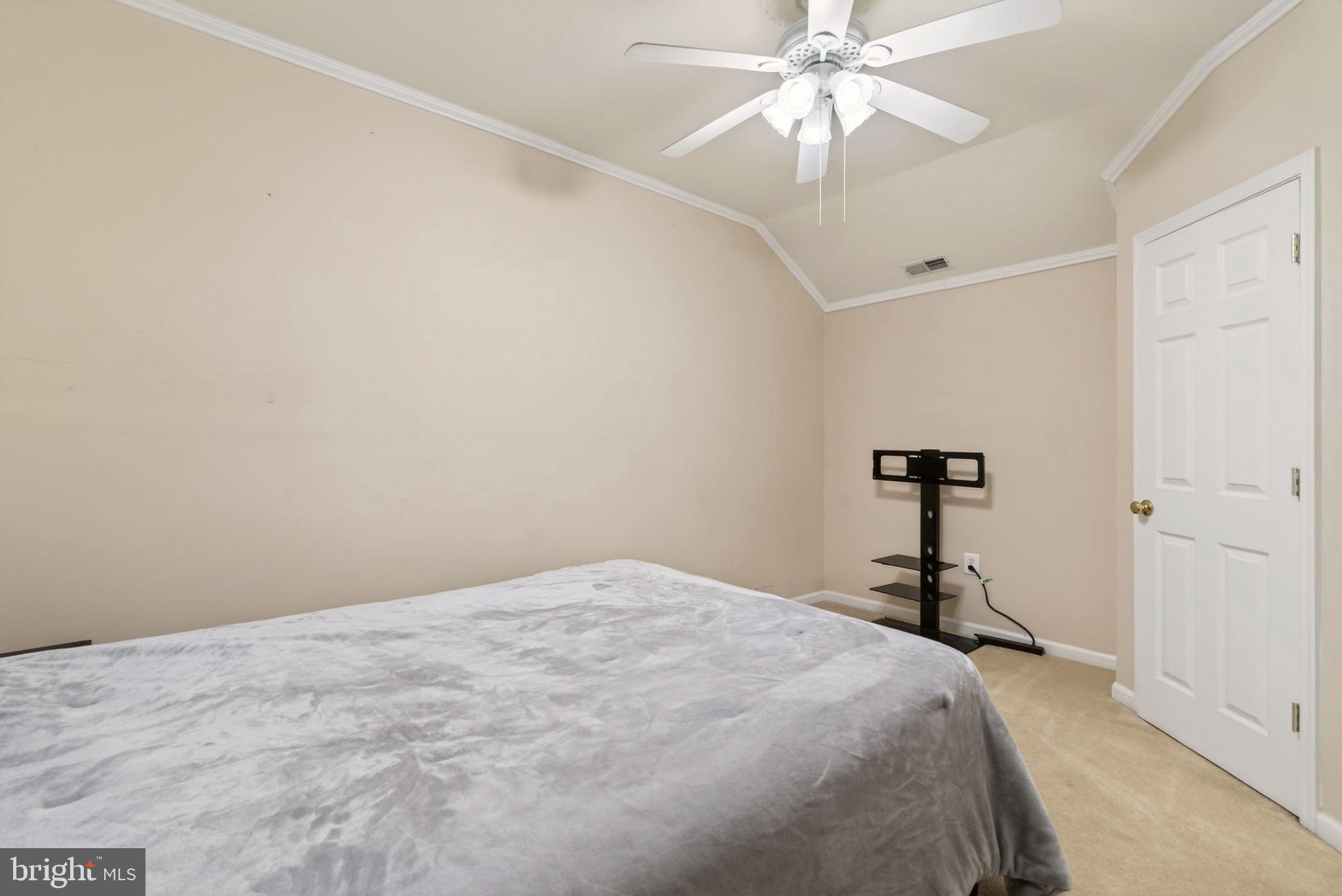 8020 Pohick Road Springfield, VA 22153 - Photo 26 of 57 a bedroom with a bed and a chandelier