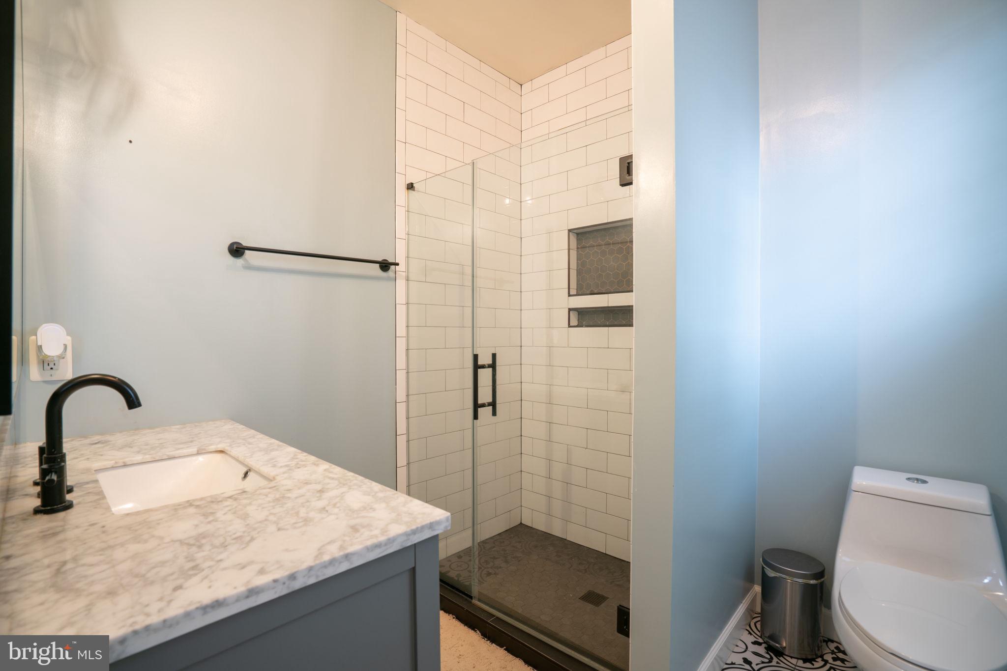 8020 Pohick Road Springfield, VA 22153 - Photo 30 of 57 a bathroom with a sink toilet and shower