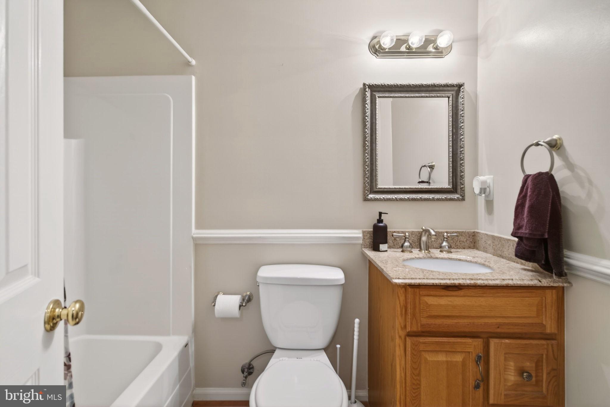 8020 Pohick Road Springfield, VA 22153 - Photo 31 of 57 a bathroom with a toilet sink and mirror