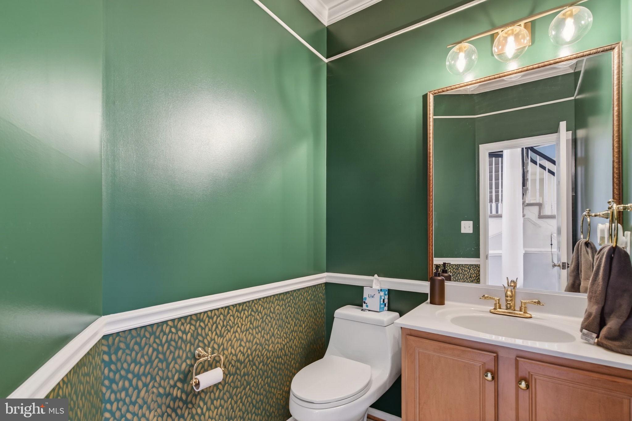 8020 Pohick Road Springfield, VA 22153 - Photo 32 of 57 a bathroom with a toilet sink and mirror